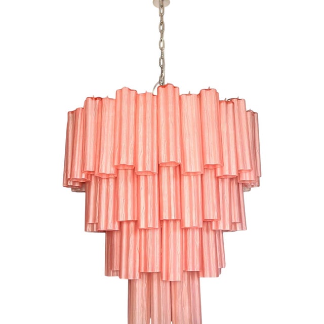 Suspended like a cascade of light and color, this pink glass Murano chandelier is a masterpiece of elegance and...