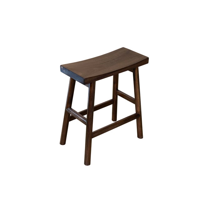 This handcrafted wooden counter stool exudes a rustic yet refined aesthetic, carved from solid wood with a deep, walnut-...