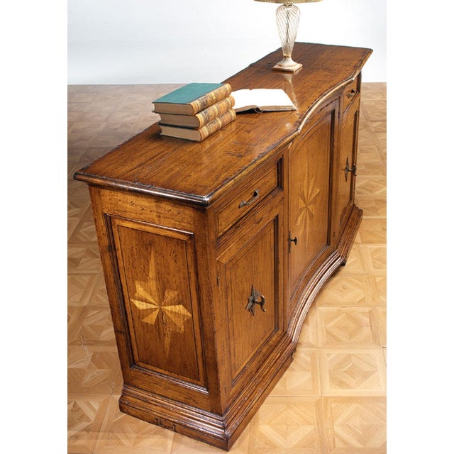 Handcrafted in Italy from walnut, this sideboard features a distinctive starburst inlay design across the center door and...