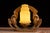 Striking Art Deco table lamp featuring a cast metal base formed by a pair of stylized eagles with wings raised in...