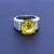 A chic and elegant diamond gemstone ring featuring a fine and natural yellow sapphire weighing 9.41 carats. The cushion-...