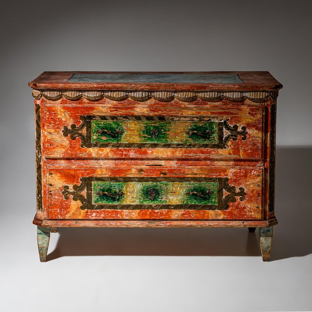 Two-drawer commode from the Irschenberg region with carved decoration on the chamfered corners and beneath the top. The...