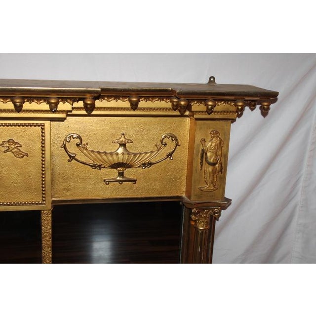 A grand-scale, early 19th-century English Regency three-part triptych overmantel mirror designed in the exquisite...
