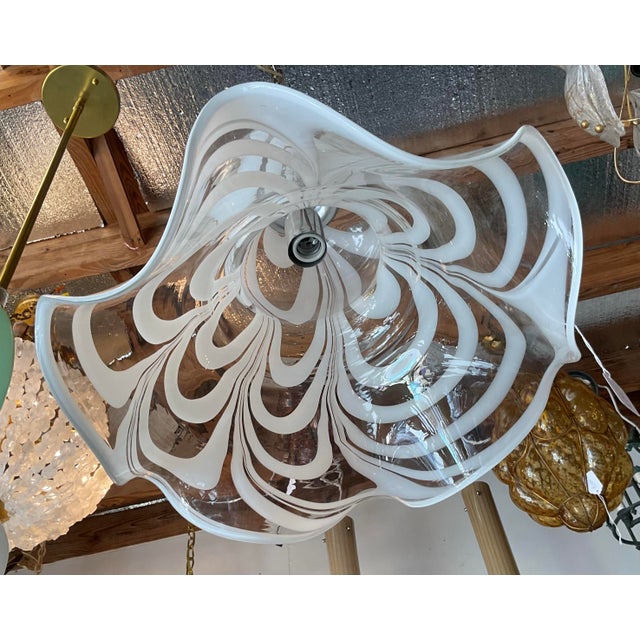 Add a touch of elegance to any space with this beautiful Murano art glass pendant light. Featuring a clear glass shade...