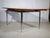 Extendable dining table in walnut with a chrome-plated metal frame from the 1960s. The warm wood surface provides a...