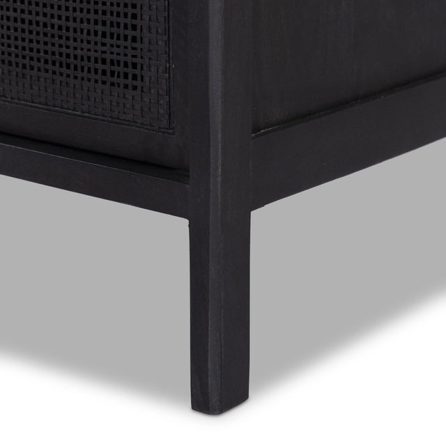 Black-finished mango frames black cane-front drawers, bringing a textural, monochromatic look to bedroom storage.