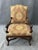 This traditional high-back upholstered arm chair features an elegant, gently arched crest and richly patterned fabric with...