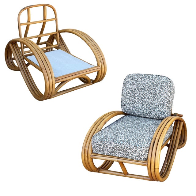 This beautifully restored Post War Mid-Century 3/4 round pretzel-arm rattan lounge chair pair, featuring sculptural three-...