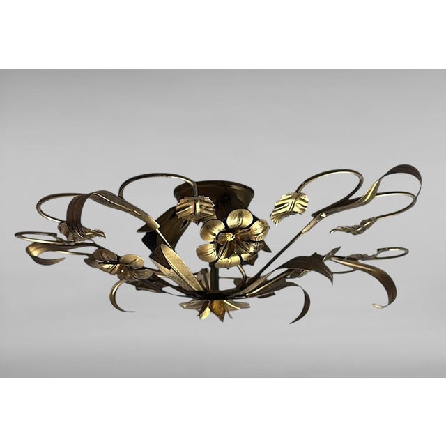 This refined gilt wrought iron flush mount ceiling light is an authentic masterpiece of Italian artistic craftsmanship...