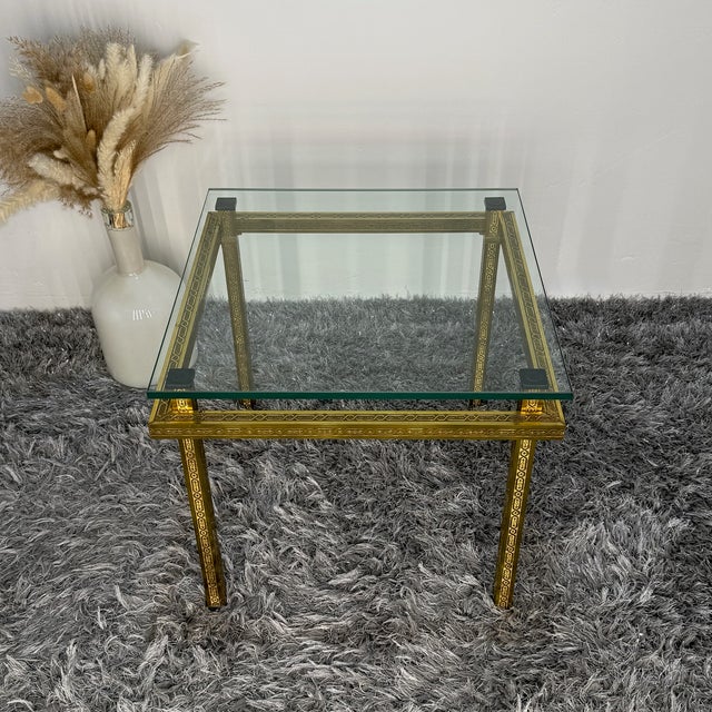 This exclusive square side table embodies the luxurious glamour of the 1970s. The frame is made of heavy brass, adorned on...