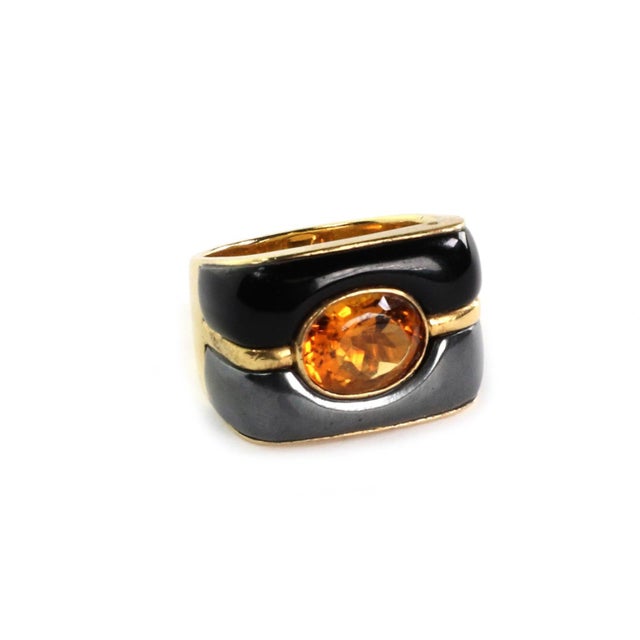 This is an authentic Ming's ring, it is crafted from 18k yellow gold featuring a long rectangular shape top with half part...