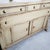Vintage style sideboard features distressed painted finish that is typical of French country or rustic farmhouse decor....