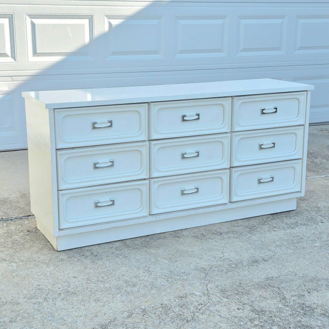 This is a super rad white laminate midcentury modern dresser that needs a lot of work. It's fully functional as is but...