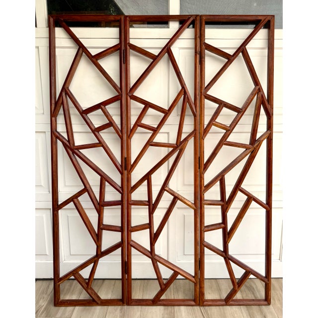 Here is an Organic Modern three-panel folding screen featuring an open, abstract geometric design in rich-toned wood....