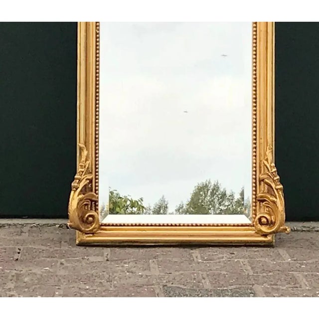 Elevate your interior with the sculptural drama of this Late 20th Century Italian Rococo Revival Floor Mirror, an ornate...