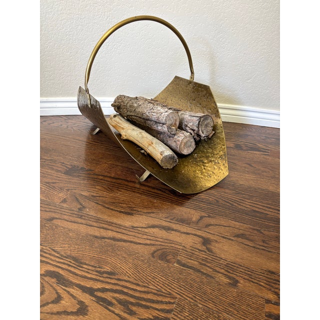 Bring warm metallic texture and sculptural style to your hearth with this large vintage hammered brass log holder. Its...