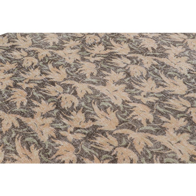 Hand-knotted in wool, this 6x9 vintage rug originating from Turkey, circa 1960-1970, is a very special piece, featuring a...