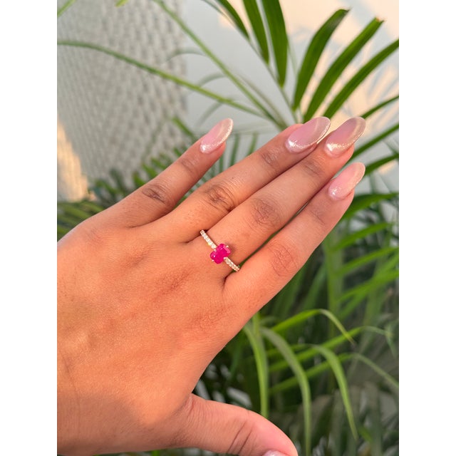 This solitaire stackable ring featuring a 1.33 carat emerald-cut ruby, set in 14K yellow gold. The ruby measuring...