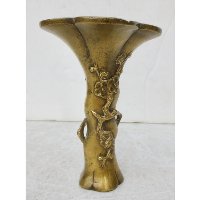Beautifully crafted cast bronze flower vase. Edo period, with prunus flowers wrapping around the wide, flaring mouth and...