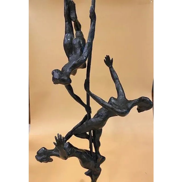 Bronze abstract sculpture of acrobats by American artist Gerald Fellman. The sculpture depicts a trio of nude acrobats...