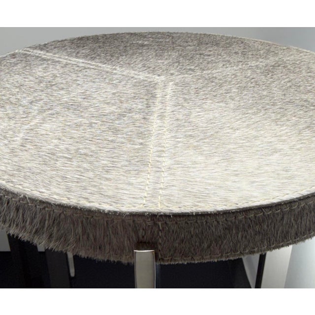 A luxurious set of perfect-condition, mid-century modern nesting tables, consisting of genuine hair-on-hide in black,...