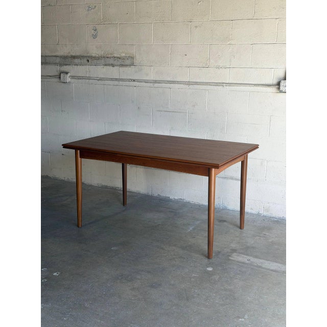 This highly functional dining table features a rectangular top with two seamless draw leaves. The clean lines and elegant...