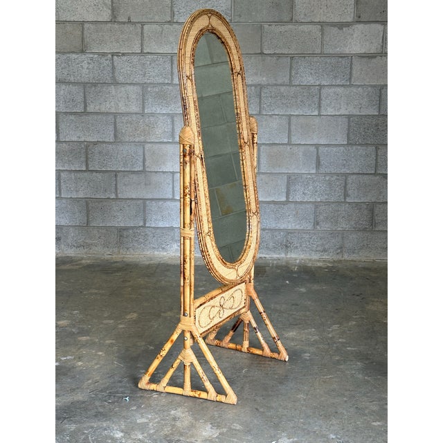 A wonderful British colonial style floor mirror with faux burnt bamboo frame and cane details. Great geometric pattern up...