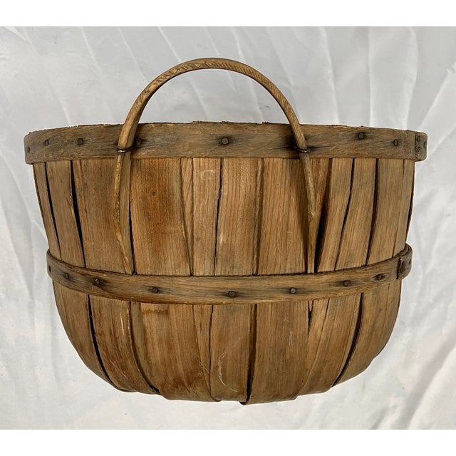 Late 1800s Handcrafted Splint Oak Basket. Bentwood supports around the center and the lip of the basket. The bottom has a...