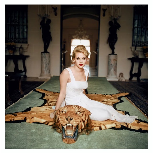 George Cameron 1961 Mrs. George (Daphne) Cameron sits on a tiger pelt in the trophy room of Laddie Sanford’s Palm Beach...
