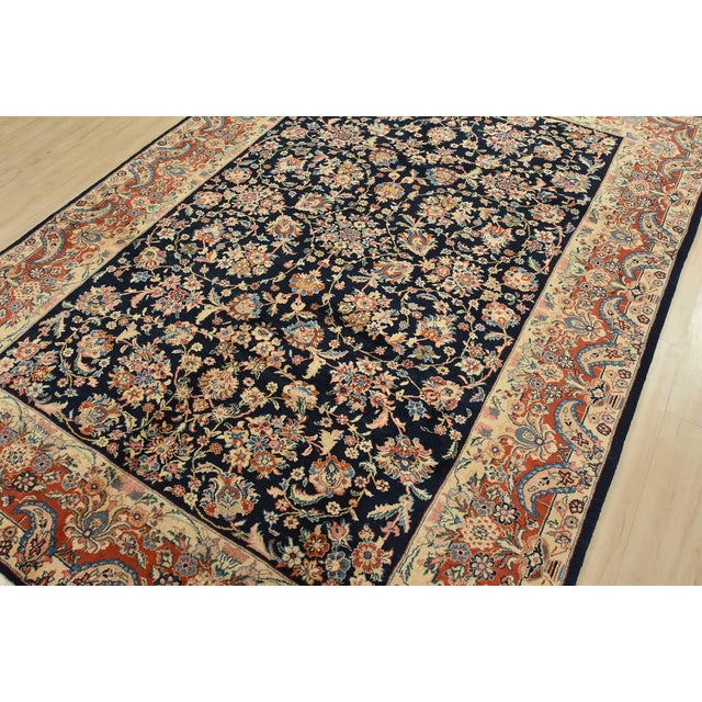 An authentic vintage traditional Sarouk rug hand-knotted with fine wool and natural dyes. This intricately woven rug...