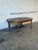 This oval coffee table features a beautifully patterned inset tile top. The frame is distinguished by a decorative...