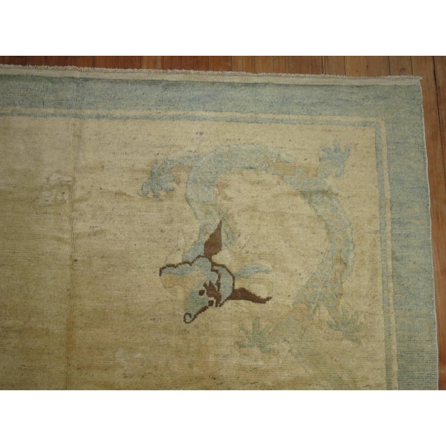 Beautiful Chinese Peking rug with a dragon medallion motif on an ivory colored field and soft baby blue border. Size is...