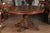 A French Napoleon III round walnut pedestal table with carved base from the mid 19th century. This French table was born...
