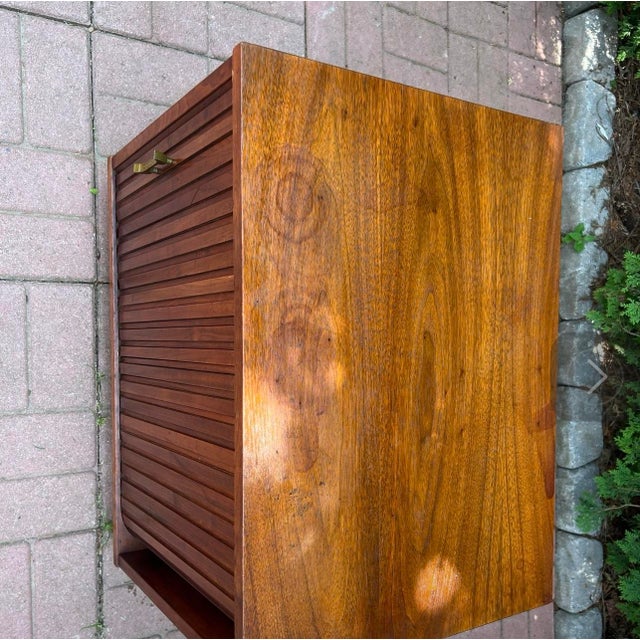 A vintage Tambour door side table with slide out tray . Well built and works perfectly . Unmarked .