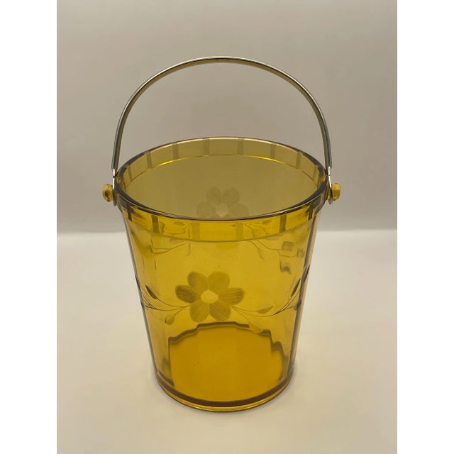 A vintage 1930’s beveled glass ice bucket etched with leaves & flowers and a chrome handle.