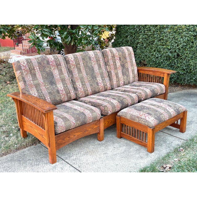 Solidly-made 1990s Arts and Crafts sofa with ottoman. Quarter sawn oak wood has beautiful lines and grain. Sturdy and...