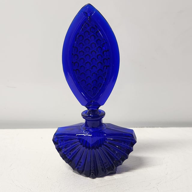 A striking mid-century Czech Art Deco–revival perfume bottle in luminous cobalt blue glass, attributed to Aurel...