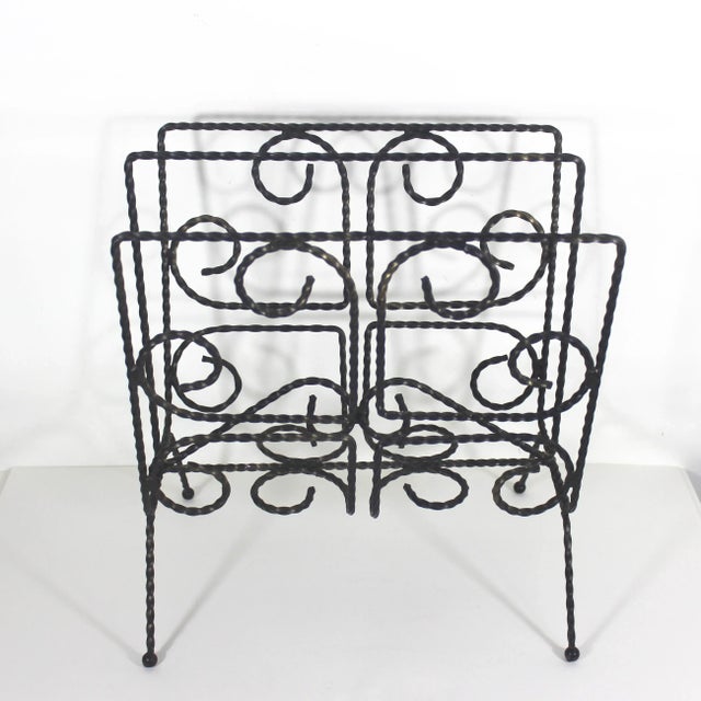 This is a mid century modern twisted black metal magazine rack or file holder. The black metal has a dusting of gold,...