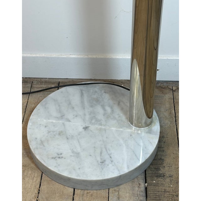 Italian arc floor lamp from the 1970s in gilded brass with six standard lights, in the style of Regiani. The circular...