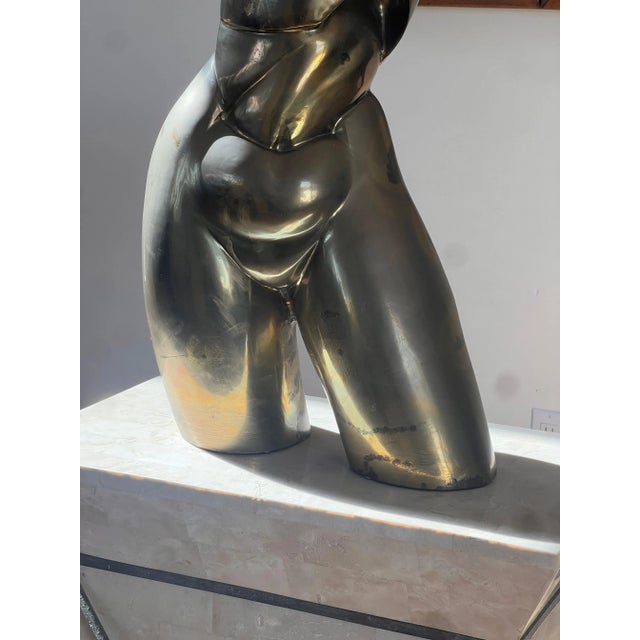 A monumental nude sculpture of a femme torso in bronze by Hattakitkosol Somchai, signed, circa 1970. A striking rarity of...