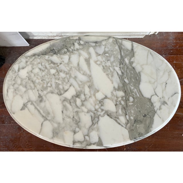 A French Provincial style oval coffee table with a genuine Italian marble top — the marble is stamped "ITALY" on the...