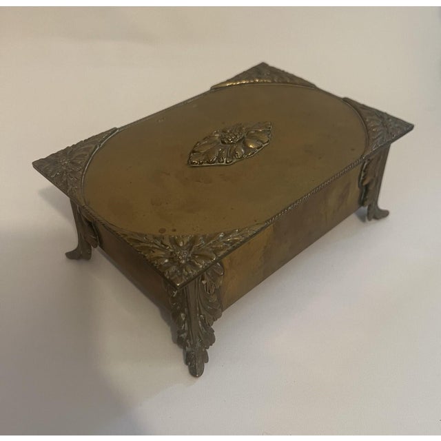 An Antique French Empire footed jewelry box made of gold-colored dore bronze It features a classical medallion design,...