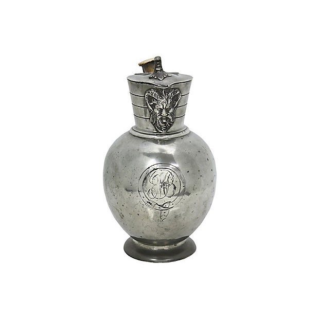 Antique decanter with natural stag horn handle and mask spout. Monogrammed on front, unsure of lettering. Maker's marks on...