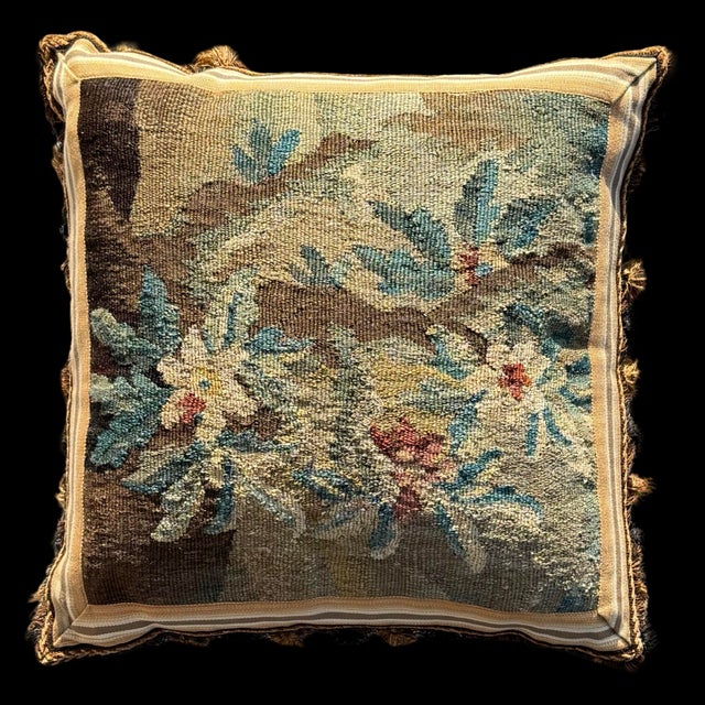 This matching pair of 18th-century antique tapestry pillows features a sophisticated floral design rendered in a muted...