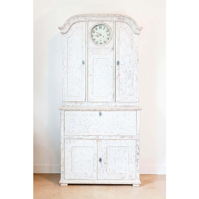 This exceptional 19th-century Swedish clock secretary, circa 1820, combines functionality with timeless Gustavian...