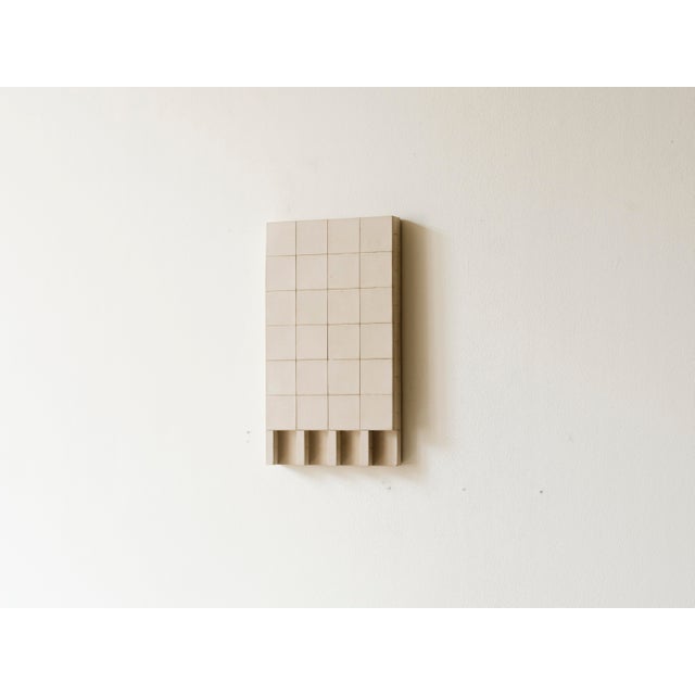 Add a touch of brutalist architecture to your space with this handcrafted concrete wall sculpture. Designed for...
