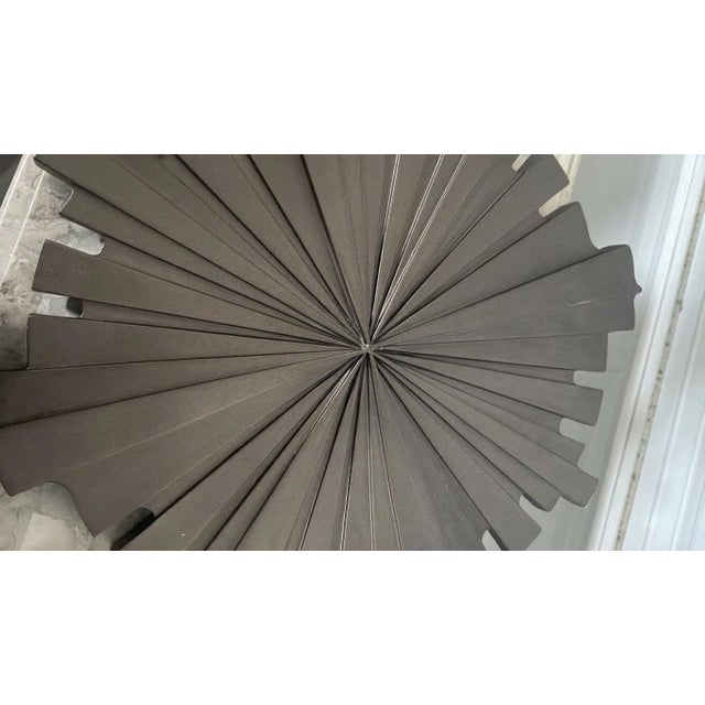 A striking, highly dimensional Mid-Century Modern sunburst wall sculpture featuring a bold Brutalist layout. This...