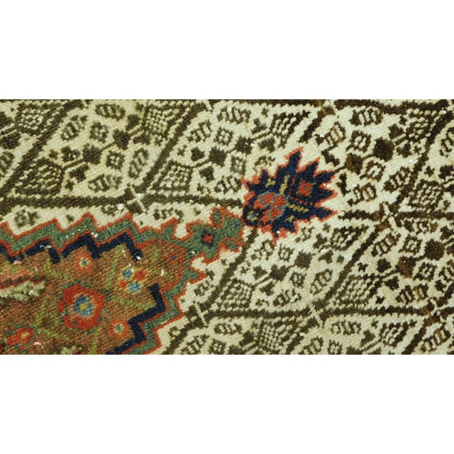 Hand-knotted antique Northwest Persian Sarab Gallery rug featuring a distinct undyed natural camel hair border decorated...