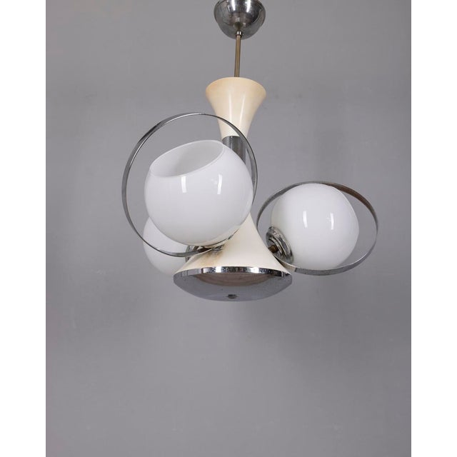 Chandelier with chromed and white metal structure and three white opal glass lampshades, Italian Space Age design, 1970s....