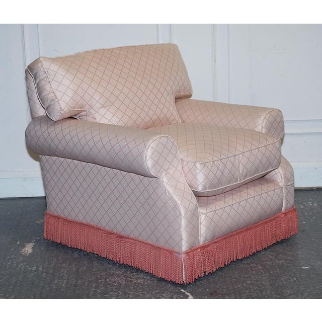 A wonderfully comfortable traditional English country house armchair with matching footstool, designed for relaxed living...